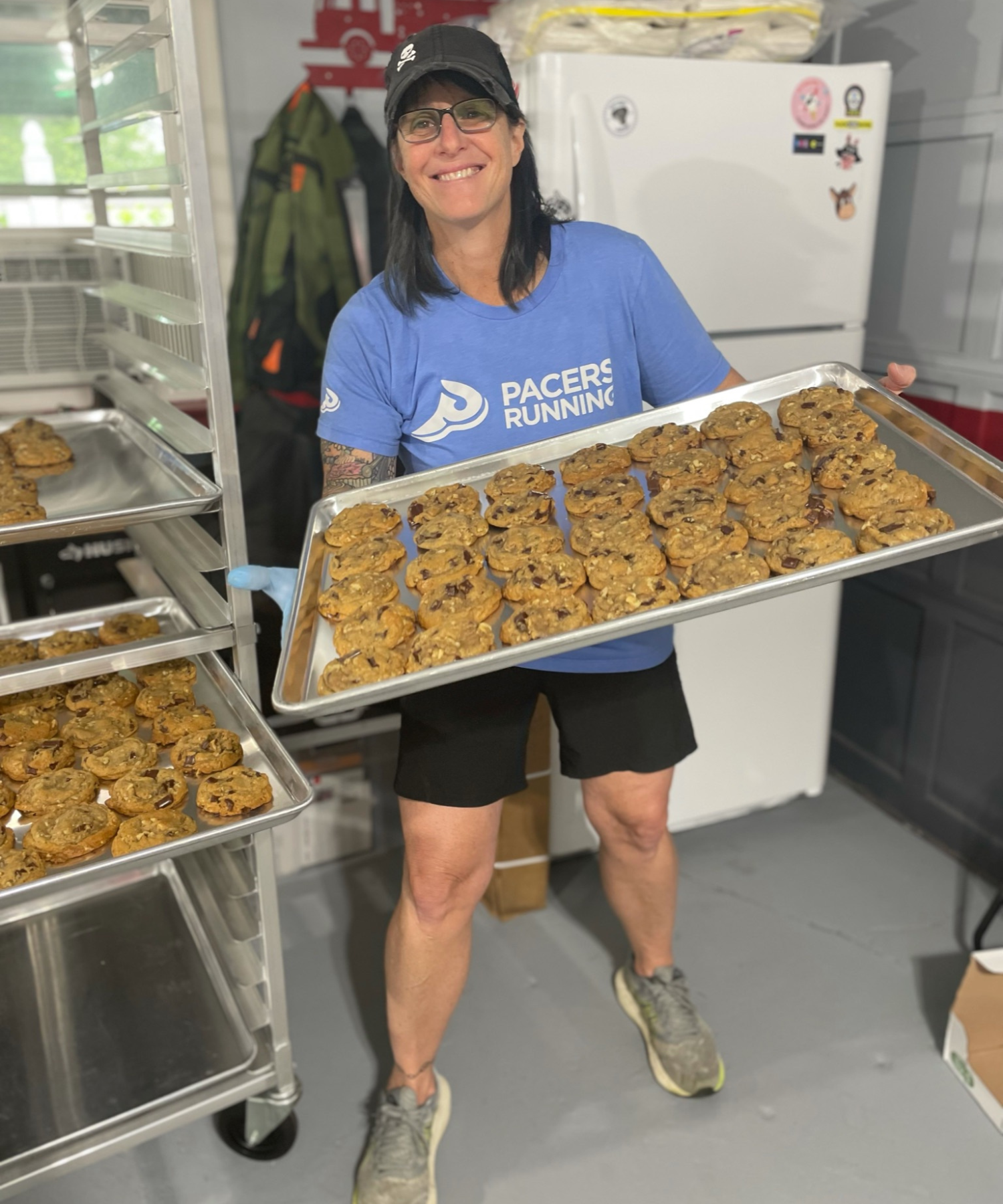 Lisa holding a tray of Scuttlebutt Bakery cookies.